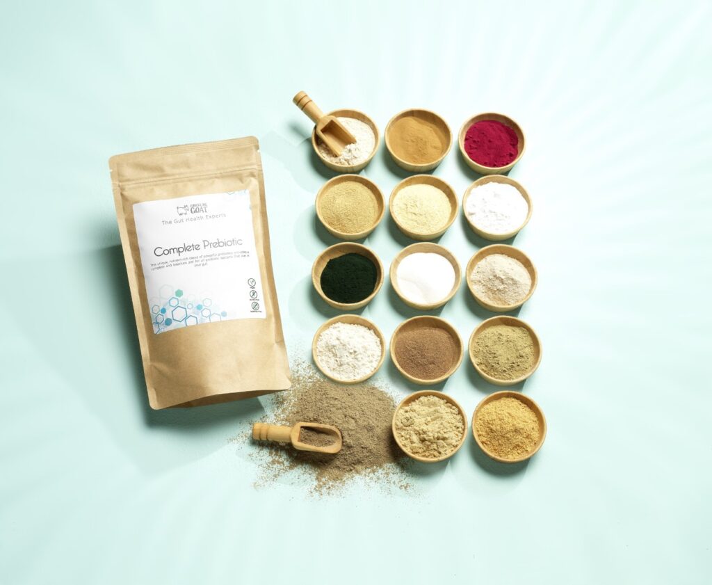 Image of Chuckling Goat Complete Prebiotic + small pots showcasing different fibres, on blue background.