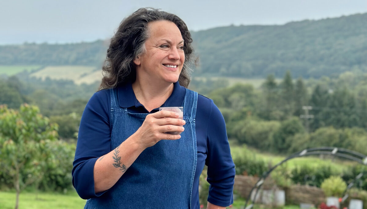 Image of Shann Jones (Chuckling Goat) drinking a gut-brain health smoothie on the Chuckling Goat farm.