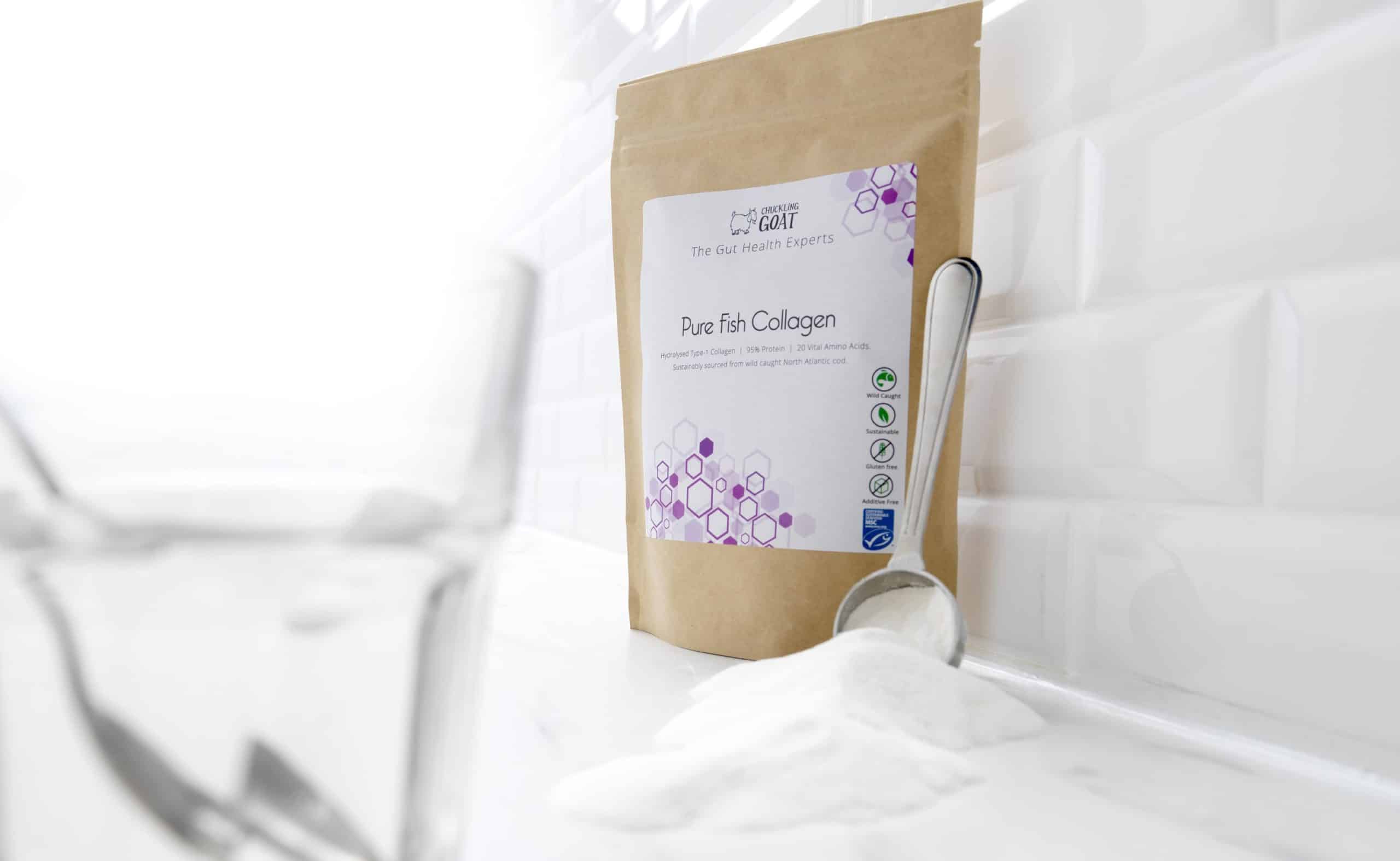 Package of Chuckling Goat Pure Fish collagen next to measuring spoon full of fish collagen on a countertop.