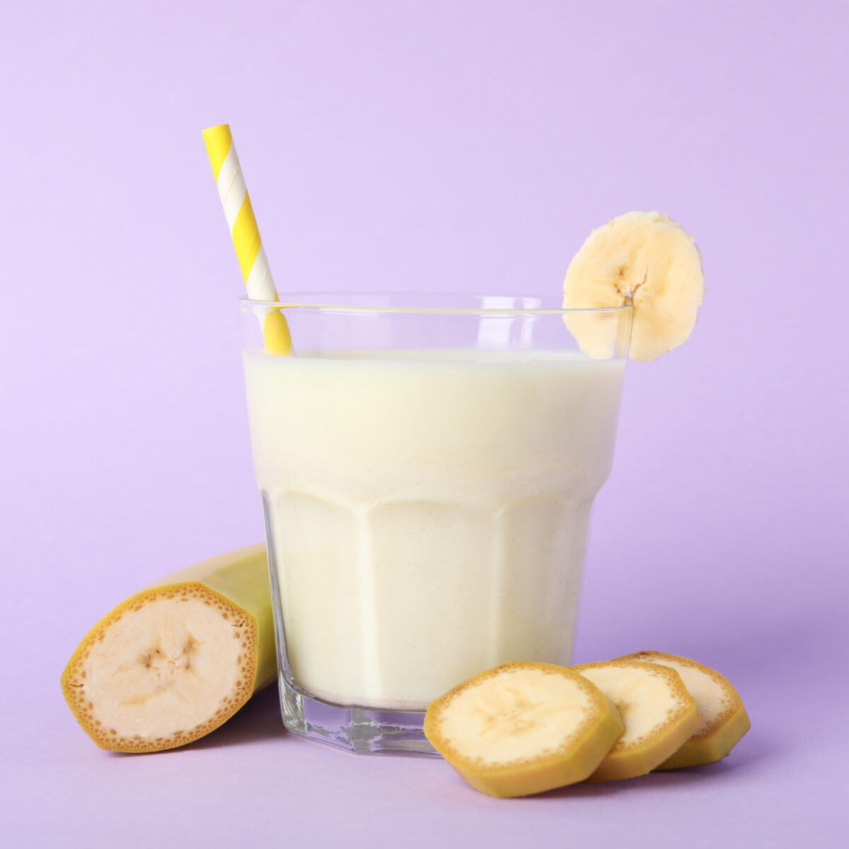Smoothie, banana smoothie on violet background