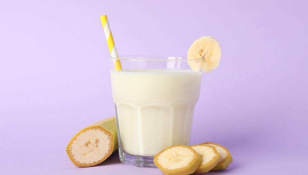 Smoothie, banana smoothie on violet background