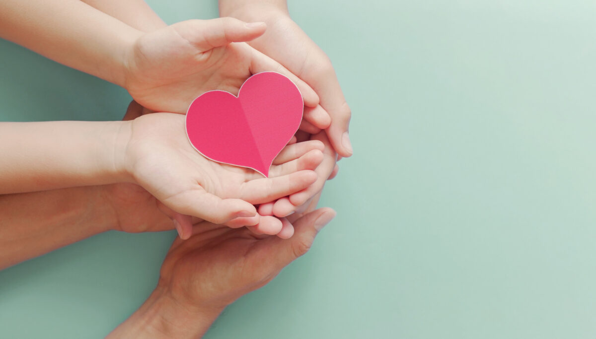 Family hands holding red heart, heart health life insurance, organ donation, volunteer charity, CSR responsibility, world heart day, world health day, world mental health day,foster home concept