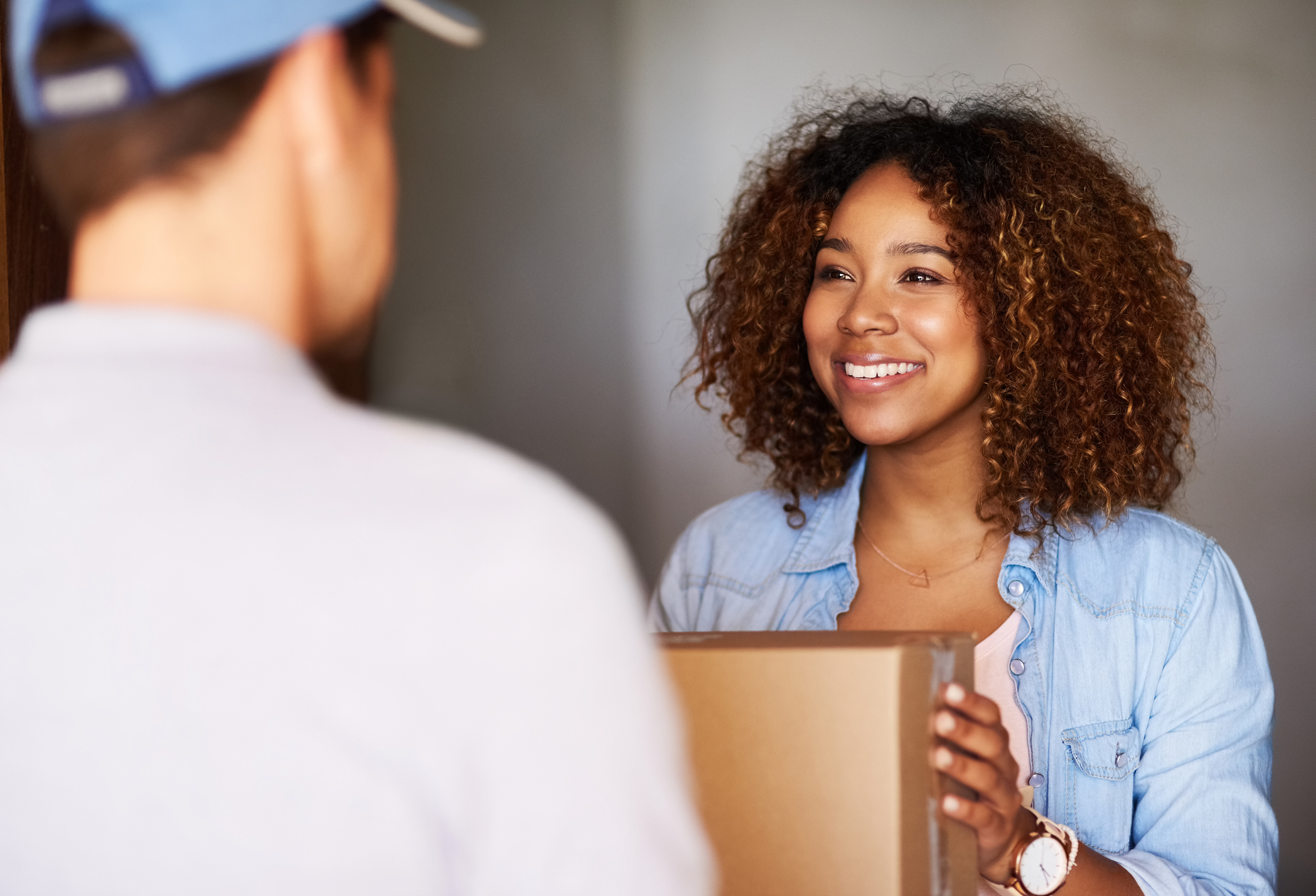 Man handing a delivery to a woman