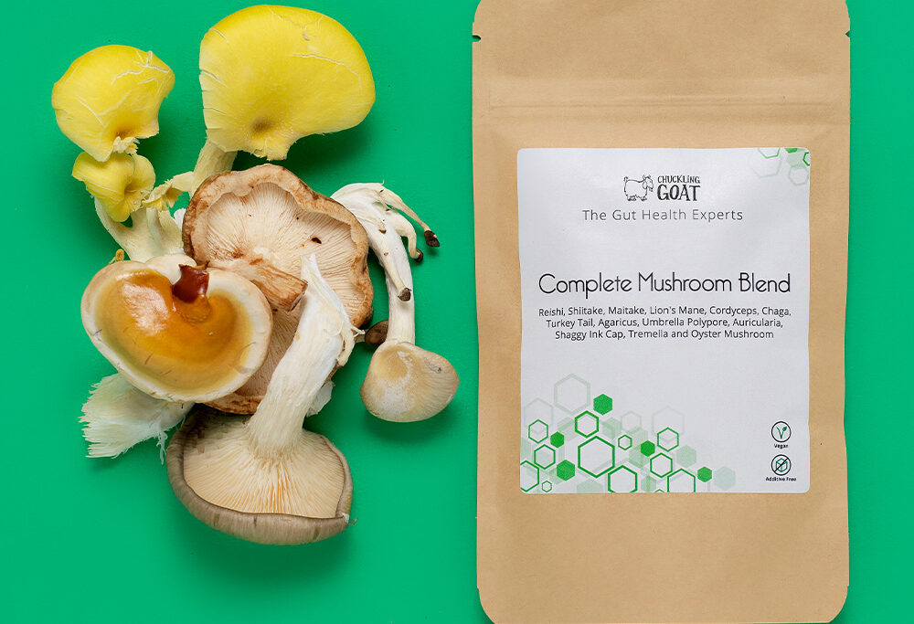Package of Chuckling Goat Complete Mushroom Blend next to assorted mushrooms.