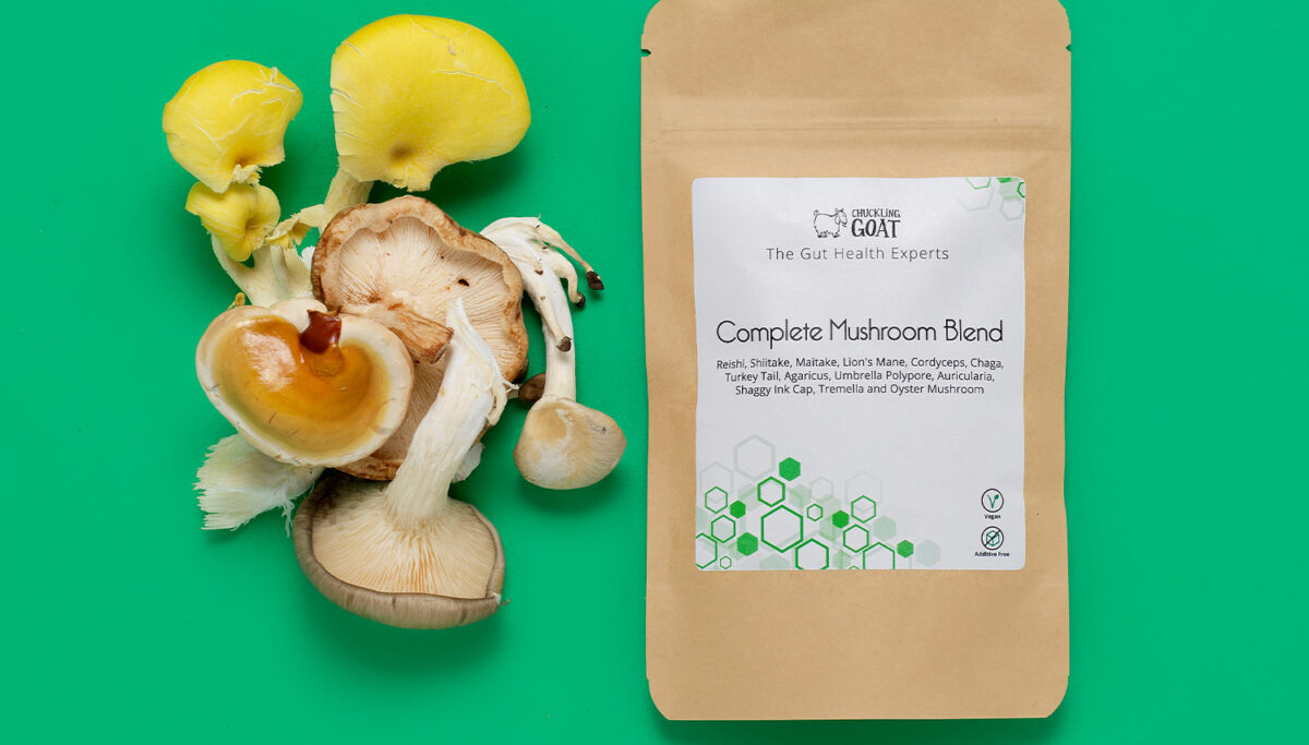 Package of Chuckling Goat Complete Mushroom Blend next to assorted mushrooms.