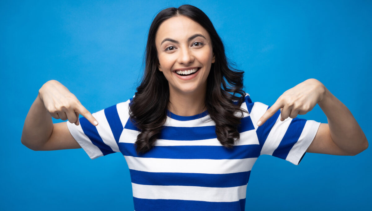 Portrait of young woman wear trendy smart casual outfit isolated on blue background