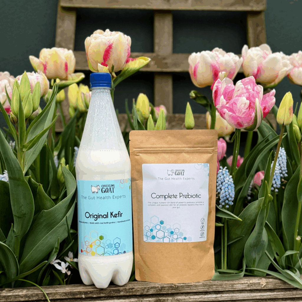 Image of Chuckling Goat Original Kefir and Complete Prebiotic among flowers.