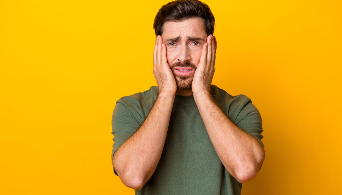 Photo of stressed depressed man isolated yellow colour background.