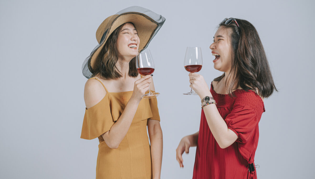 fashionable women summer wear holding wine glass studio shoot cut out with gray background