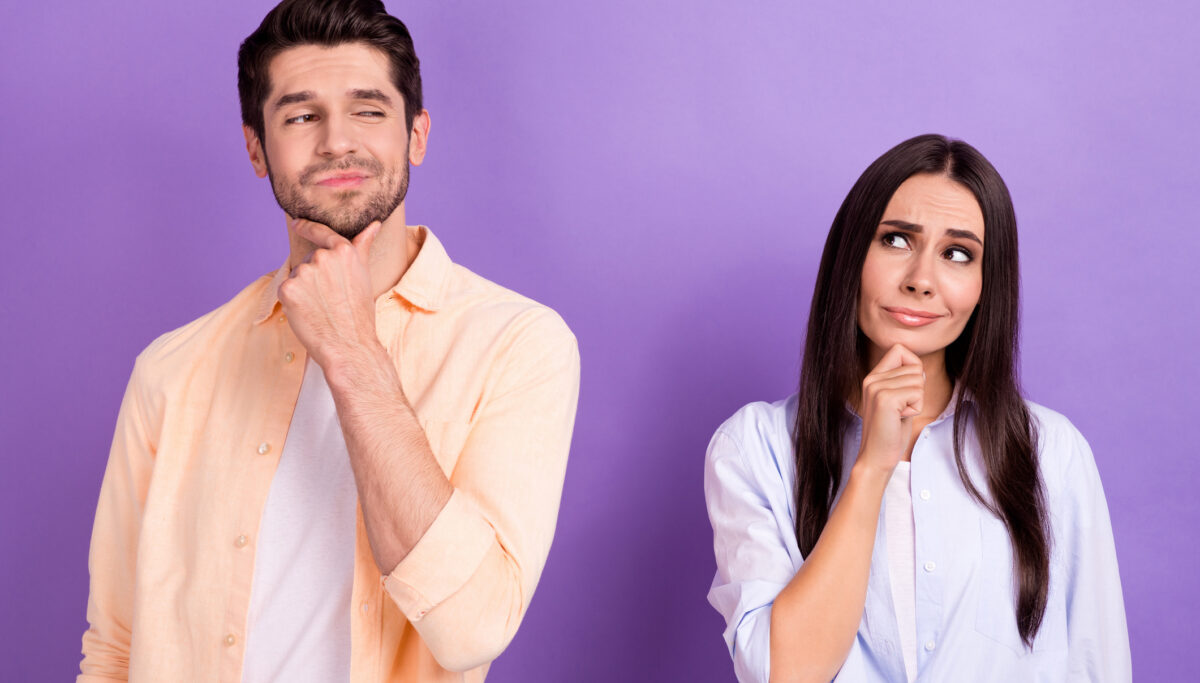 Unsure funny man and woman isolated purple color background.