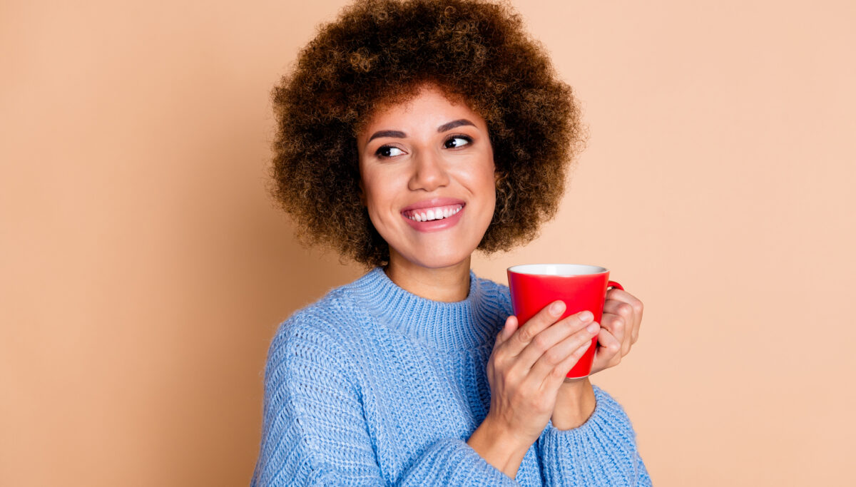 Photo of woman dressed in knit sweater holding latte look isolated on pastel color background.