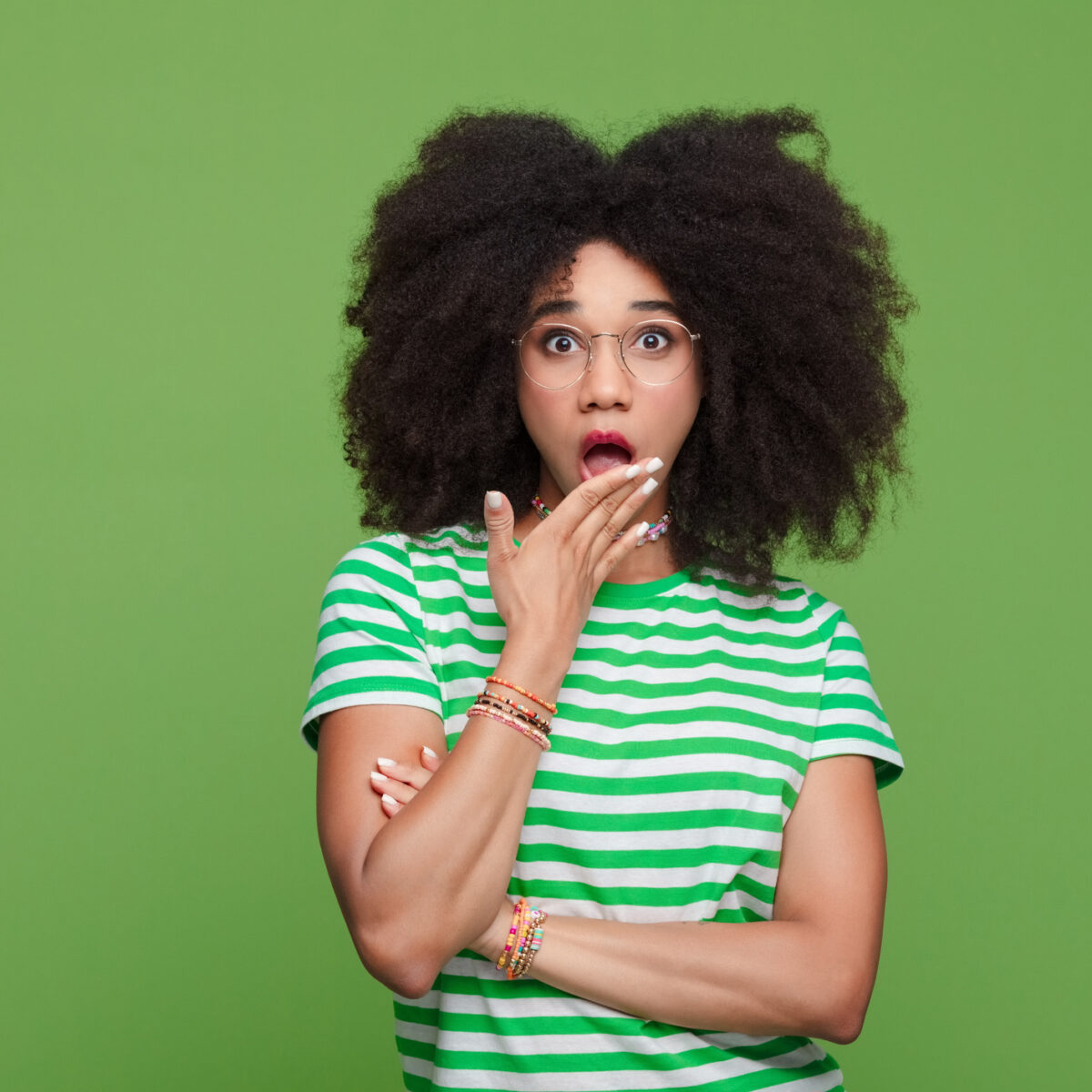 Leaking, urgency, rushing to toilet, Shocked afro-american woman, surprised, hand over mouth, on green isolated background