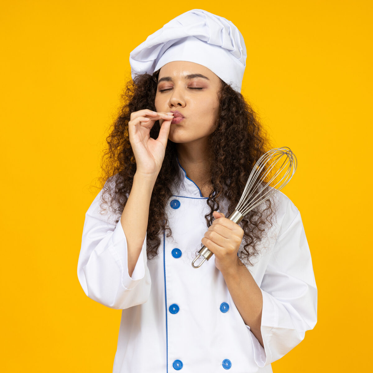 Young woman in chefs hat, meal prep concept, mum in the kitchen, isolated yellow background