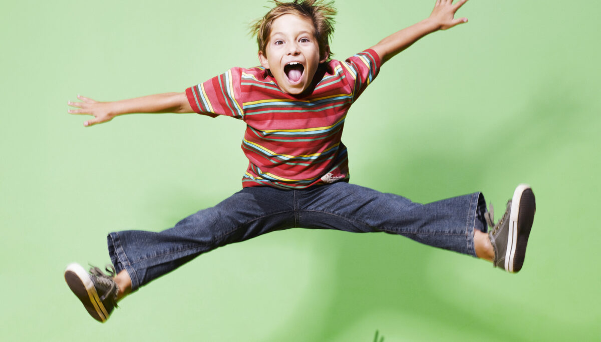 Young boy jumping in mid-air, energy, energetic